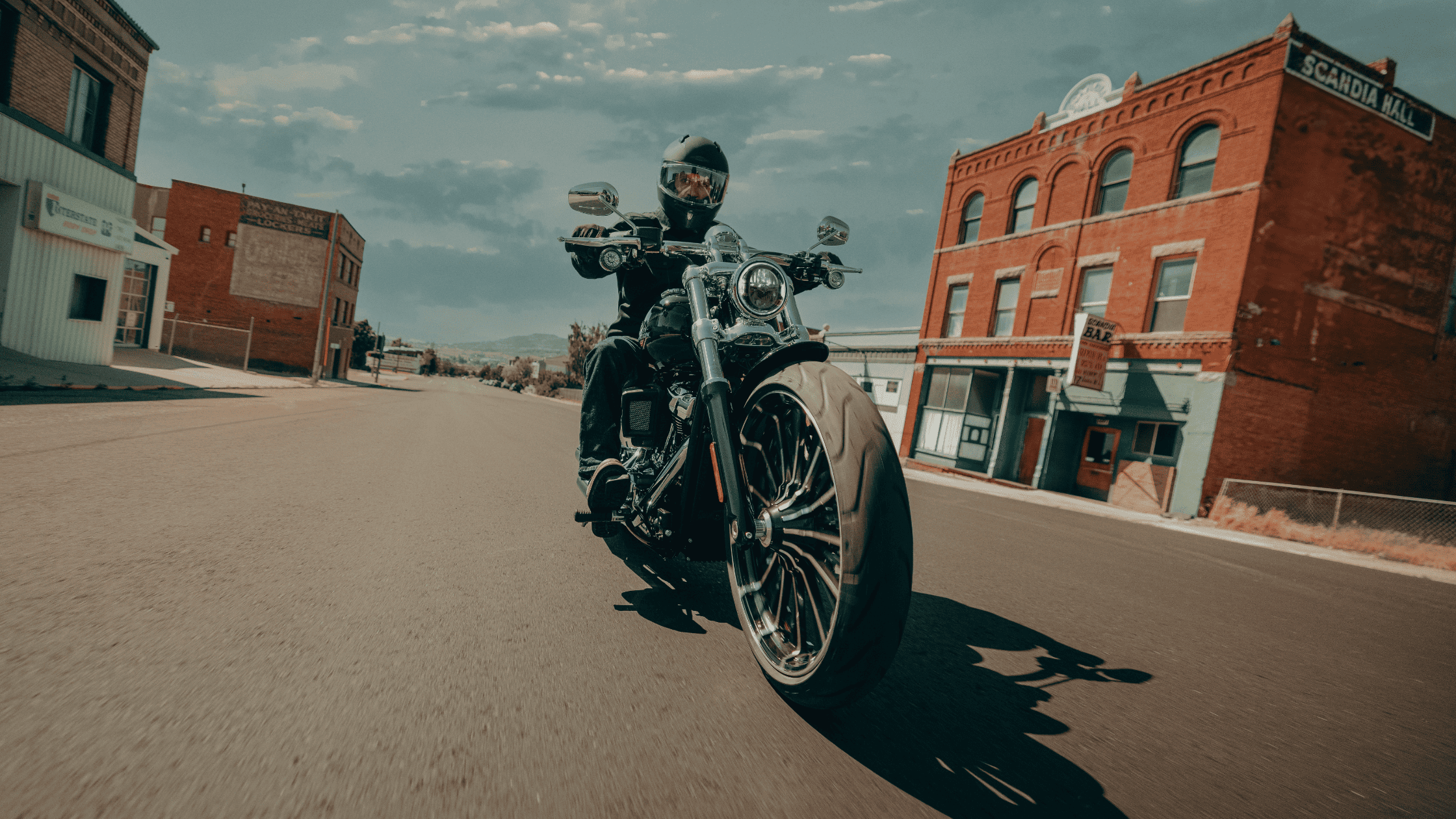 2025 Harley-Davidson Breakout motorcycle in motion, showcasing bold design and wide front tire.