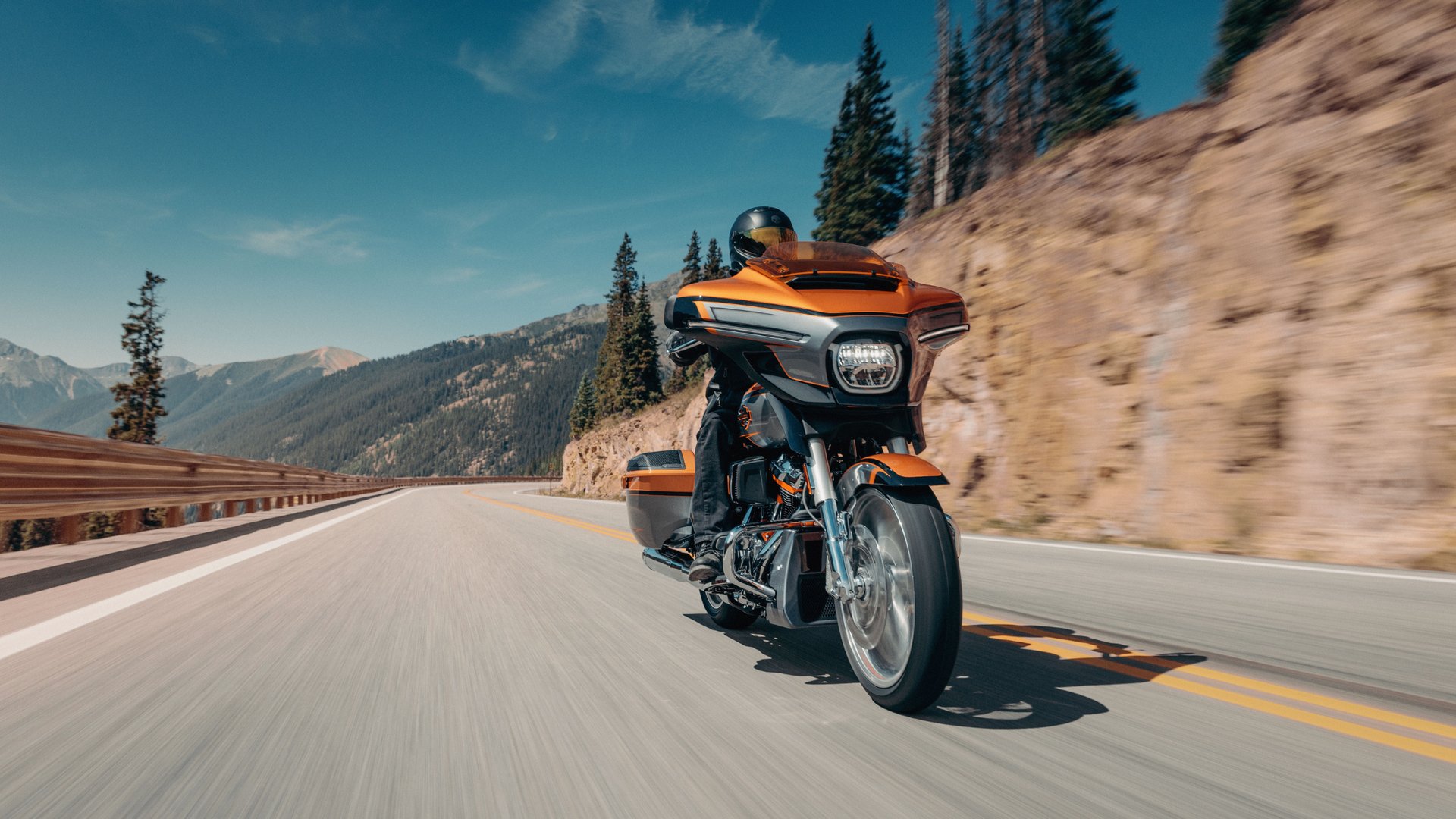 2026 Harley-Davidson® CVO™ Street Glide® touring motorcycle riding along a scenic mountain highway.
