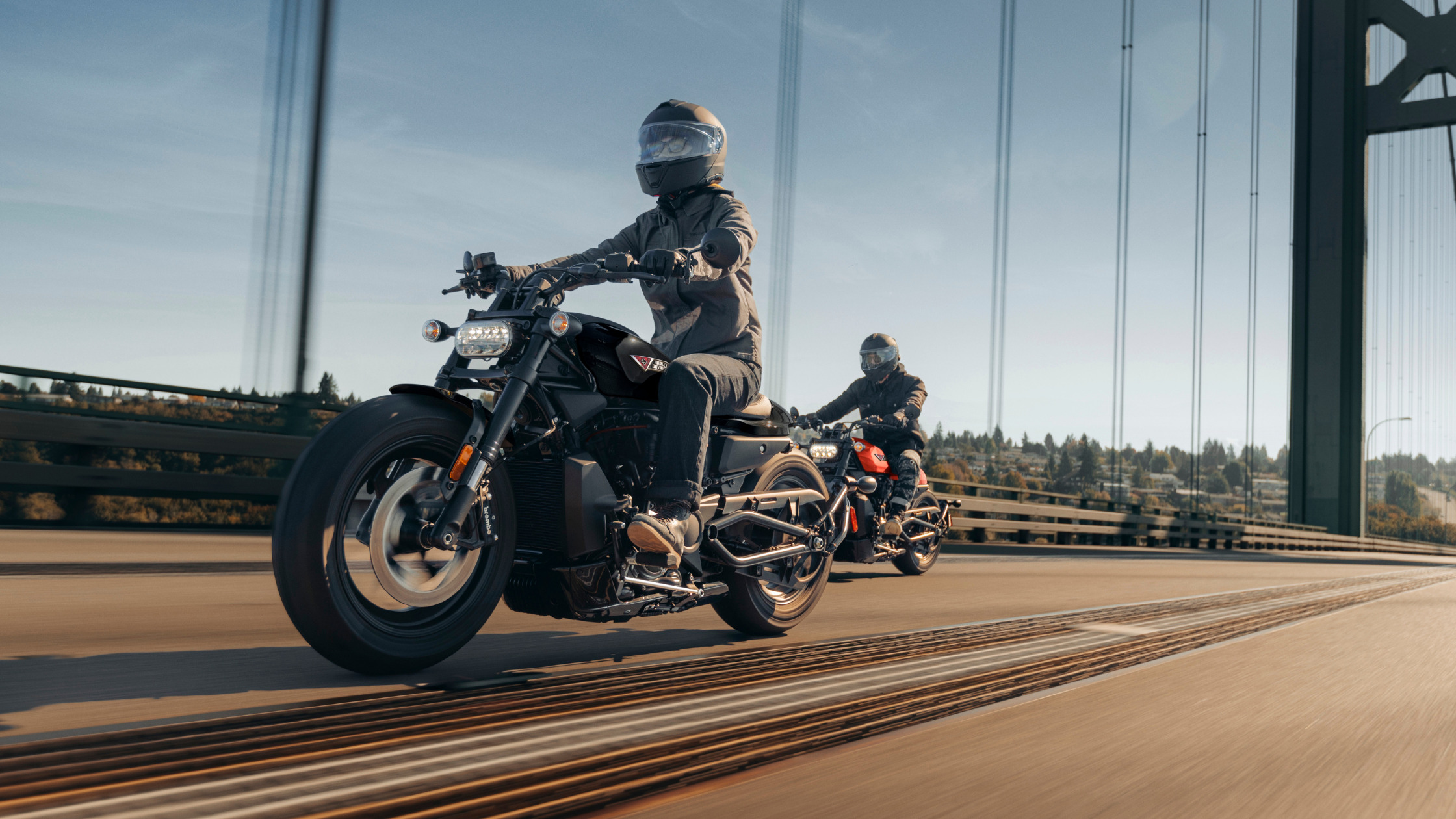 2026 Harley-Davidson® Sportster® S motorcycles crossing suspension bridge, front rider leading group ride.